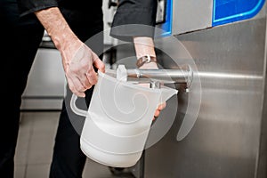 Pouring pasteurized milk for ice cream photo