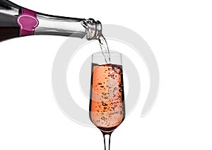 Pouring pink rose champagne from bottle to glass