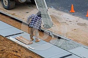 Pouring in process of pouring concrete cement on newly paved sidewalk