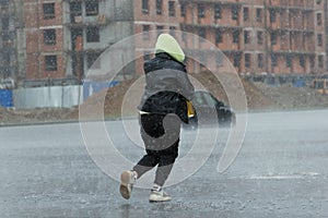 pouring rain, rainy weather, people running jumping over puddles