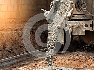 Pouring ready-mixed concrete after placing steel reinforcement to make the road by mixing in construction site