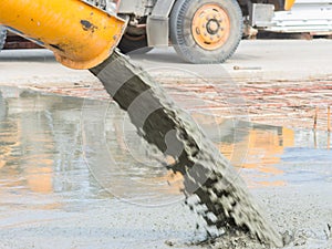 Pouring ready-mixed concrete after placing steel reinforcement to make the road by mixing mobile the concrete mixer