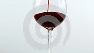 Pouring red wine of bottle. Isolated beverage, alcohol, winery footage on white background