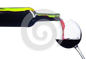 Pouring red wine from bottle to glass isolated on white