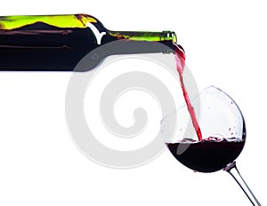 Pouring red wine from bottle to glass isolated on white