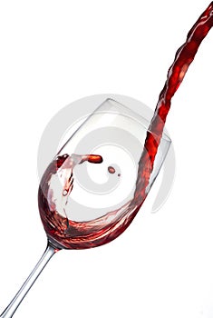 Pouring red wine into a crystal glass and creates waves, splash.