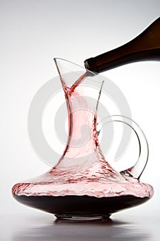 Pouring red wine into decanter