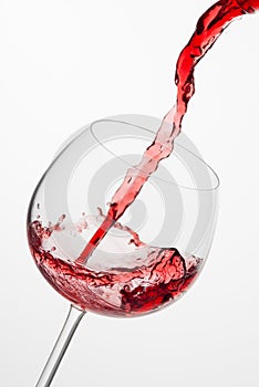 Pouring red wine into glass.