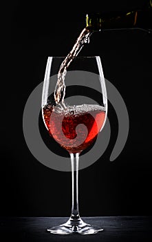 Pouring red wine into a glass