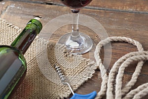 Pouring red wine glass against wooden background