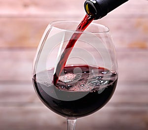 Pouring red wine into glass