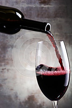 Pouring red wine into the glass