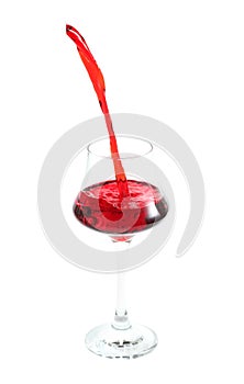 Pouring red wine in glass on white background