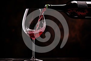 Pouring red wine to glass party restaurant bar gourmet celebration luxury taste splashing grape alcohol expensive drink