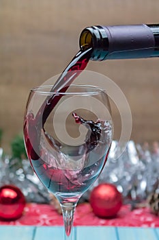 Pouring red wine into a wine glass