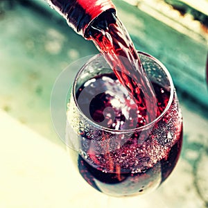 pouring red wine. Wine in a glass, selective focus, motion blur,