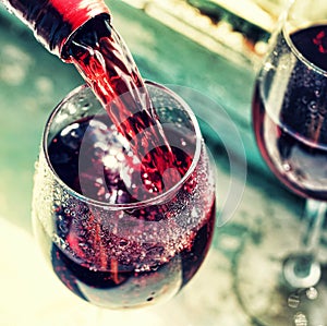 pouring red wine. Wine in a glass, selective focus, motion blur,