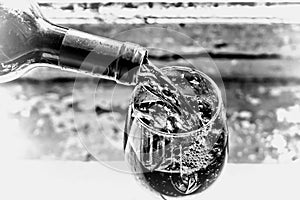 Pouring red wine. Wine in a glass, selective focus, motion blur, Red wine in a glass. Sommelier pouring the wine into the glass. T