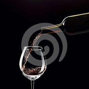 Pouring red wine in a wineglass