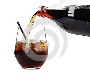 Pouring refreshing cola into glass with ice cubes