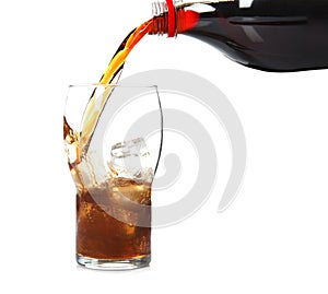 Pouring refreshing cola into glass with ice cubes on white