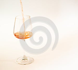 Pouring rose wine in a glass