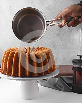 Pouring a rum sauce on rum bundt cake
