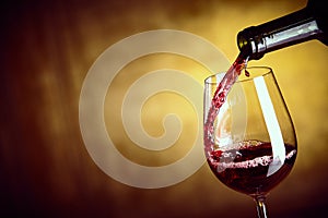 Pouring a single glass of red wine from a bottle