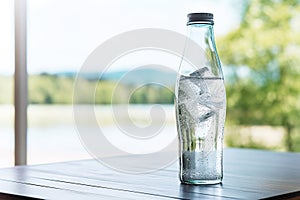 Pouring soda water from bottle into glass