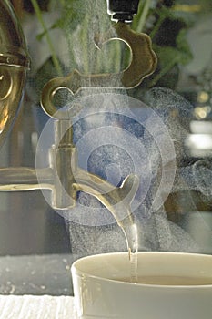 pouring Steam tea cup samovar