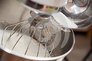 Pouring sugar into bowl for making bakery
