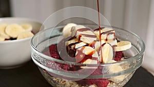 Pouring Sweet Caramel Syrop for Oatmeal Breakfast. 4K Slowmotion.