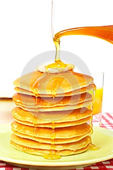 Pouring syrup on the pancakes photo