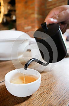 pouring tea , tea cup and tea pot
