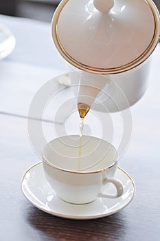 pouring tea , tea cup and tea pot or hot tea