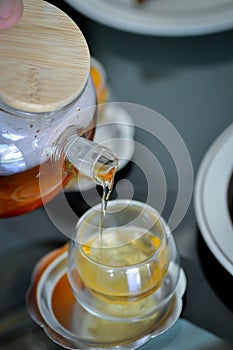 Pouring tea , tea cup and tea pot