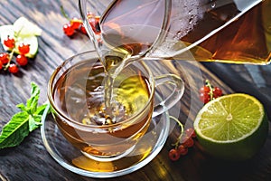 Pouring tea into a glass cup