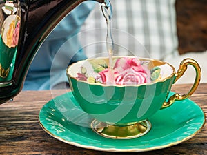 Pouring a tea into a green cup