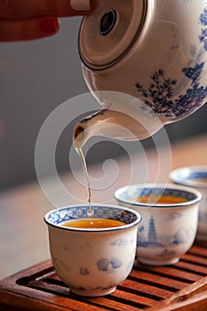 Pouring tea in traditional chinese teaware.