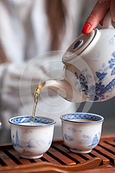 Pouring tea in traditional chinese teaware.