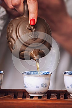 Pouring tea in traditional chinese teaware.