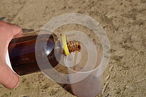 Pouring thick glyphosate solution in a beaker