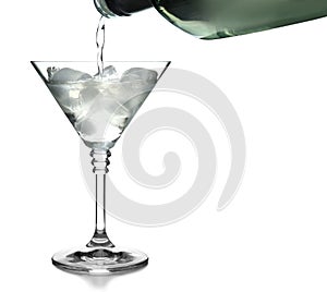 Pouring vermouth into glass with ice cubes for martini cocktail