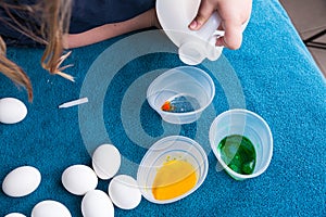 Pouring vinegar into tubs for easter egg dyeing