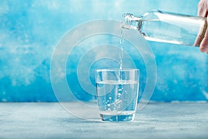 Pouring water from bottle into glass