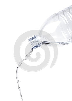 Pouring water from bottle isolated on white