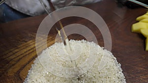 Pouring water into a bowl with rice