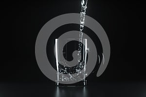Pouring the water into the glass, dark background, 3d rendering