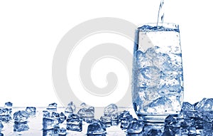 Pouring water into glass with ice isolated on white background