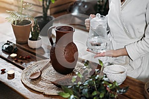 Pouring water into jug with cacao. Ceremonial cocoa ritual